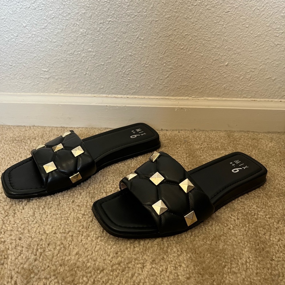 Black sandals with gold details